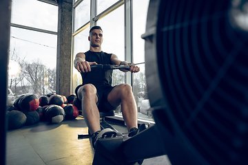 Image showing The male athlete training hard in the gym. Fitness and healthy life concept.