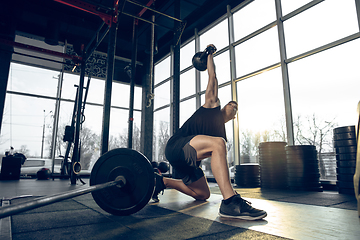 Image showing The male athlete training hard in the gym. Fitness and healthy life concept.