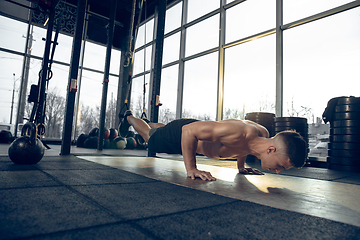 Image showing The male athlete training hard in the gym. Fitness and healthy life concept.