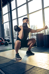 Image showing The male athlete training hard in the gym. Fitness and healthy life concept.