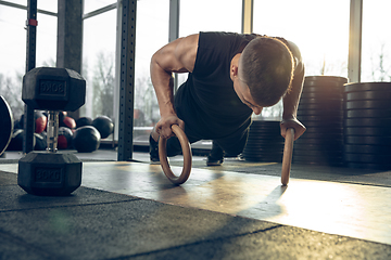 Image showing The male athlete training hard in the gym. Fitness and healthy life concept.