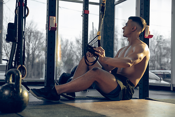 Image showing The male athlete training hard in the gym. Fitness and healthy life concept.