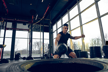 Image showing The male athlete training hard in the gym. Fitness and healthy life concept.