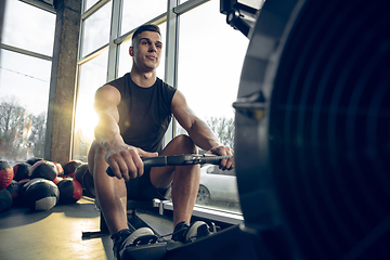 Image showing The male athlete training hard in the gym. Fitness and healthy life concept.