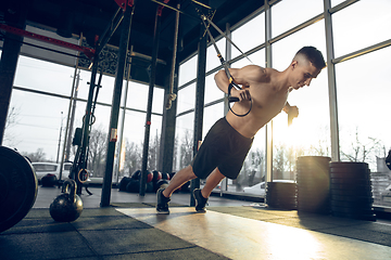 Image showing The male athlete training hard in the gym. Fitness and healthy life concept.