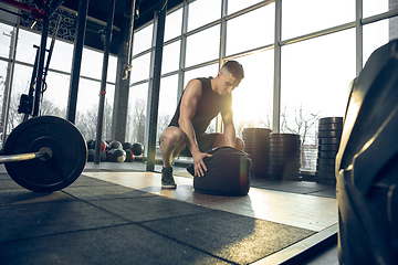 Image showing The male athlete training hard in the gym. Fitness and healthy life concept.