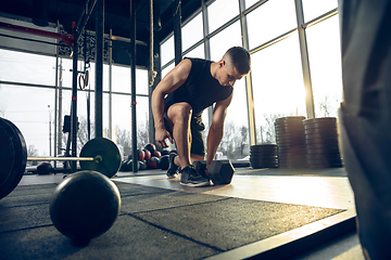 Image showing The male athlete training hard in the gym. Fitness and healthy life concept.