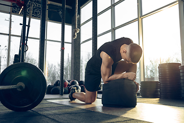 Image showing The male athlete training hard in the gym. Fitness and healthy life concept.