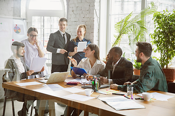 Image showing Group of young business professionals having a meeting, creative office