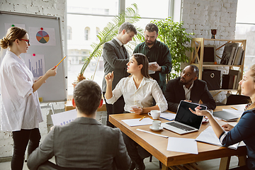 Image showing Group of young business professionals having a meeting, creative office