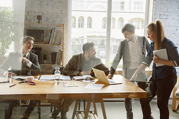 Image showing Group of young business professionals having a meeting, creative office