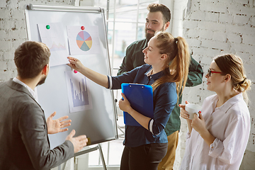 Image showing Group of young business professionals having a meeting, creative office