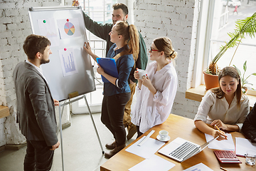 Image showing Group of young business professionals having a meeting, creative office