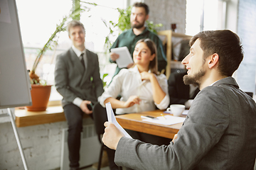 Image showing Group of young business professionals having a meeting, creative office