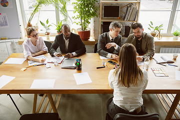 Image showing Group of young business professionals having a meeting, creative office