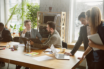 Image showing Group of young business professionals having a meeting, creative office