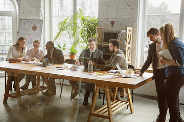 Image showing Group of young business professionals having a meeting, creative office