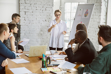 Image showing Group of young business professionals having a meeting, creative office