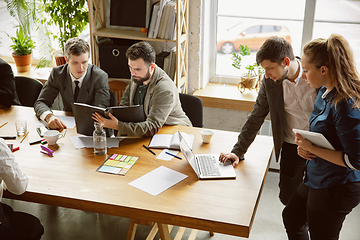 Image showing Group of young business professionals having a meeting, creative office