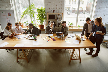 Image showing Group of young business professionals having a meeting, creative office