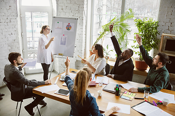 Image showing Group of young business professionals having a meeting, creative office