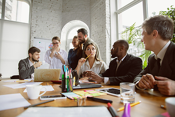 Image showing Group of young business professionals having a meeting, creative office