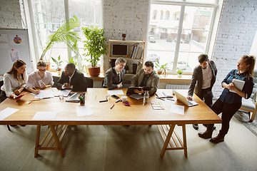 Image showing Group of young business professionals having a meeting, creative office