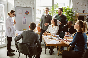 Image showing Group of young business professionals having a meeting, creative office