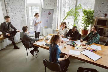 Image showing Group of young business professionals having a meeting, creative office