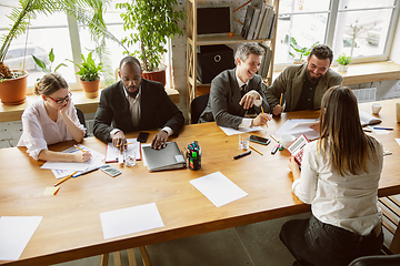 Image showing Group of young business professionals having a meeting, creative office