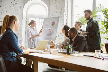 Image showing Group of young business professionals having a meeting, creative office