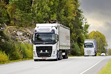 Image showing Two White Volvo Semi Trailer Trucks on Road