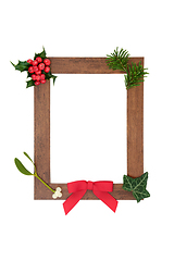 Image showing Wooden Frame with Winter Greenery Decoration 