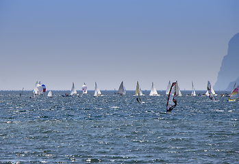 Image showing Windsurfer surfing and sailboats sailing the wind on waves In la