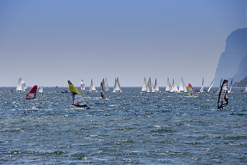 Image showing Windsurfer surfing and sailboats sailing the wind on waves In la