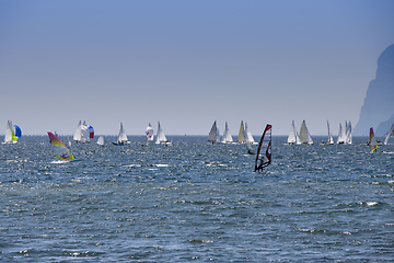Image showing Windsurfer surfing and sailboats sailing the wind on waves In la