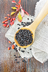 Image showing Barberry dried in spoon on dark board top