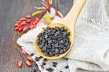 Image showing Barberry dried in spoon on dark board