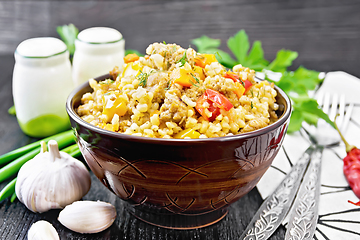 Image showing Barley porridge with minced meat in bowl on board