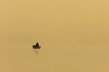 Image showing fisherman silhouette on a foggy morning