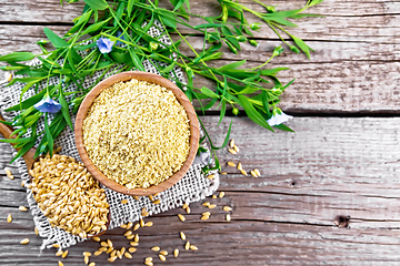 Image showing Bran flaxseed in bowl on old board top