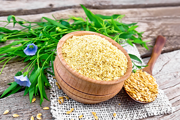 Image showing Bran flaxseed in bowl on old board