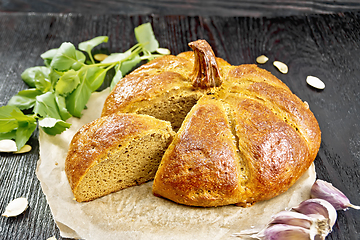 Image showing Bread pumpkin cut on a black board