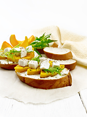 Image showing Bruschetta with pumpkin and ricotta on light board