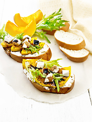 Image showing Bruschetta with pumpkin and sauce on light board