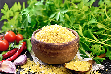 Image showing Bulgur in bowl with vegetables on black board