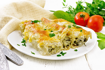 Image showing Cannelloni with curd and spinach in plate on board