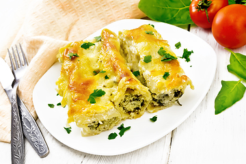 Image showing Cannelloni with curd and spinach in plate on white board