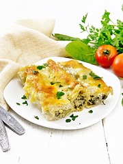 Image showing Cannelloni with curd and spinach in plate on wooden board