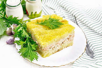 Image showing Casserole with potatoes and fish in plate on white board